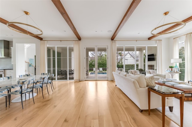 living room featuring light wood finished floors and beam ceiling