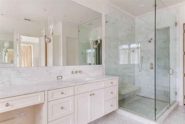 bathroom with a shower stall, visible vents, crown molding, and vanity