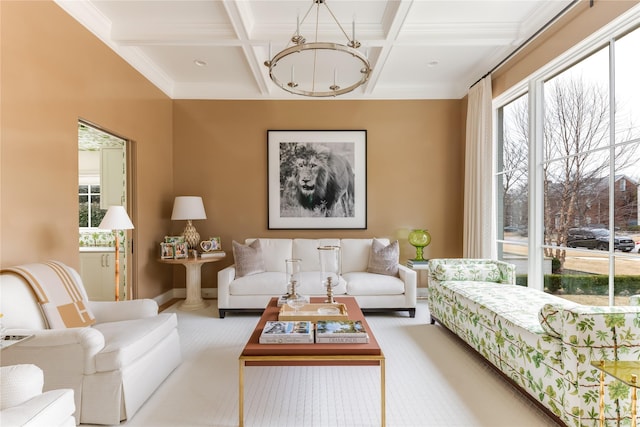 living room with beamed ceiling, plenty of natural light, coffered ceiling, and a notable chandelier