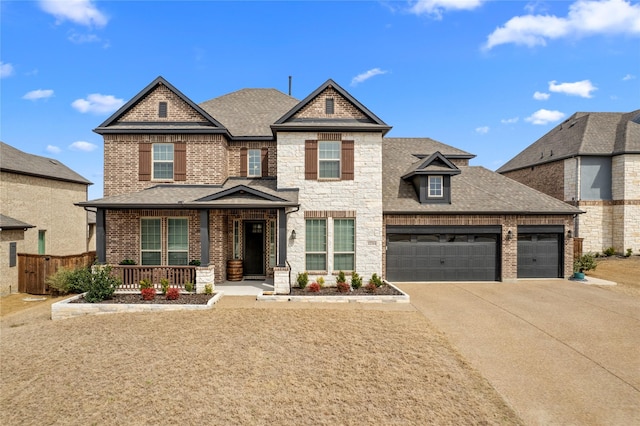 view of front of home with a shingled roof, covered porch, a garage, stone siding, and driveway