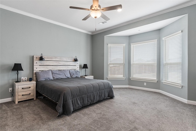 carpeted bedroom featuring visible vents, multiple windows, baseboards, and crown molding