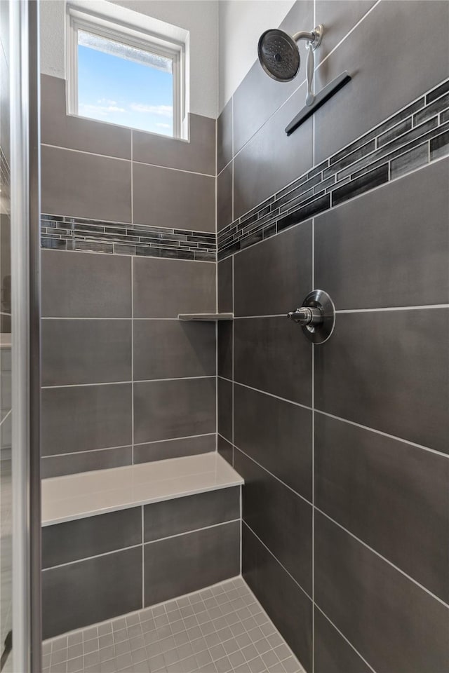 full bath with a tile shower