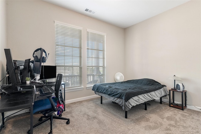 carpeted bedroom with visible vents and baseboards