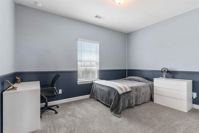 bedroom featuring carpet floors, visible vents, and baseboards