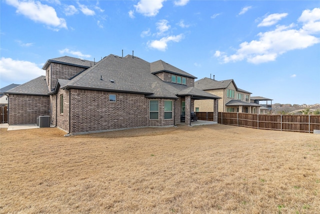 rear view of house featuring a yard, a patio area, fence, and cooling unit