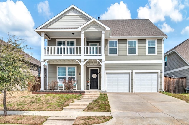 view of front of property featuring a garage, concrete driveway, a balcony, covered porch, and fence