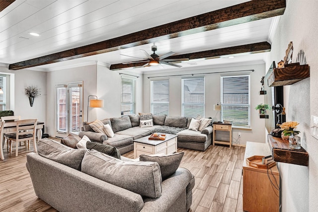 living room featuring crown molding, light wood finished floors, beam ceiling, and a ceiling fan