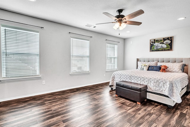 bedroom featuring a textured ceiling, recessed lighting, wood finished floors, visible vents, and baseboards