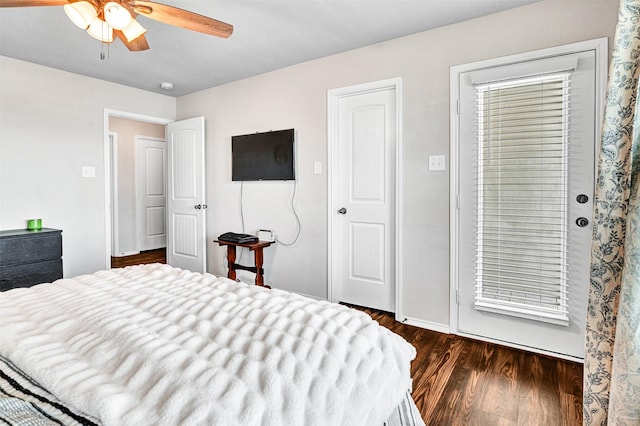 bedroom featuring ceiling fan, dark wood-type flooring, and baseboards