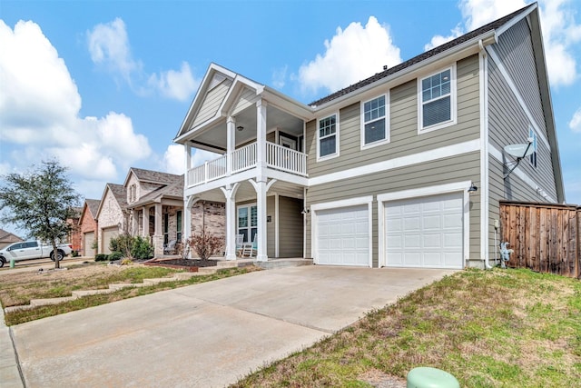 view of front of house featuring a porch, a balcony, a garage, fence, and concrete driveway