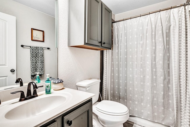 bathroom with a textured ceiling, a textured wall, curtained shower, toilet, and vanity