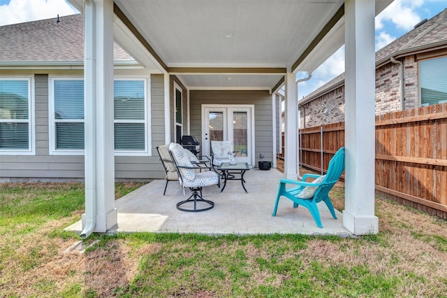 view of patio / terrace with area for grilling and fence