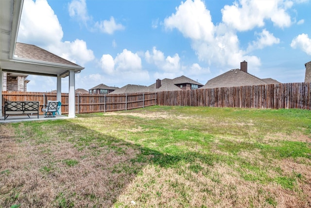 view of yard featuring a patio area and a fenced backyard