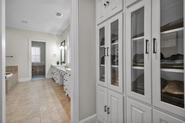 2204 Emerson Ln, Carrollton, TX 75010 - bathroom featuring vanity, a bath, tile patterned flooring, and baseboards