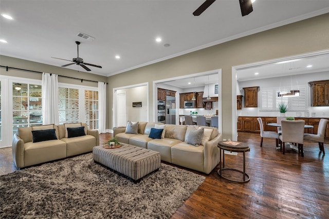 living area featuring ceiling fan, recessed lighting, visible vents, dark wood-style floors, and crown molding