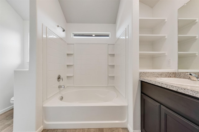 bathroom with tub / shower combination, vanity, toilet, and wood finished floors