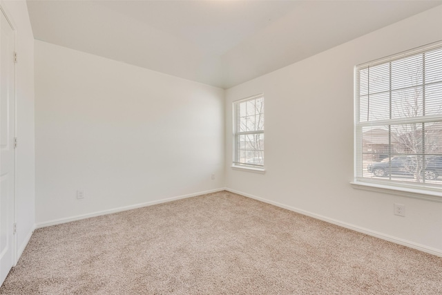 empty room featuring carpet floors and baseboards