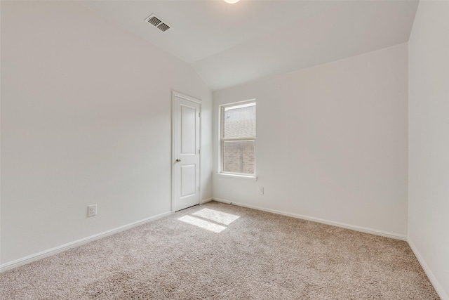 unfurnished room featuring light carpet, vaulted ceiling, visible vents, and baseboards