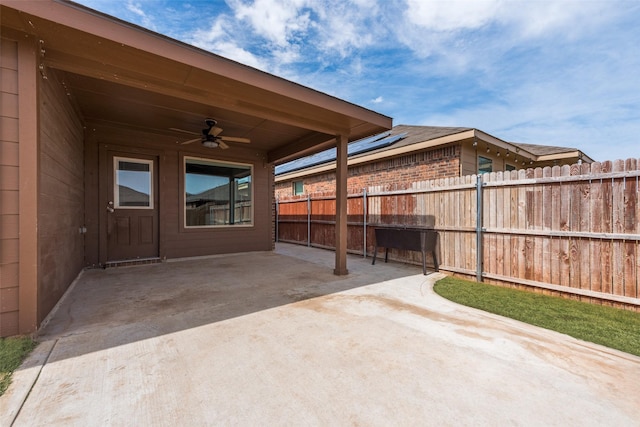 view of patio with fence and a ceiling fan