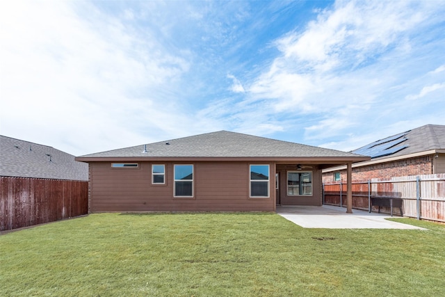 back of house featuring ceiling fan, a fenced backyard, a lawn, and a patio