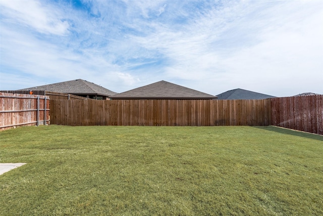 view of yard with a fenced backyard