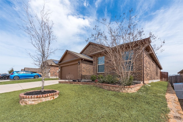 ranch-style house featuring a front yard, fence, concrete driveway, and brick siding