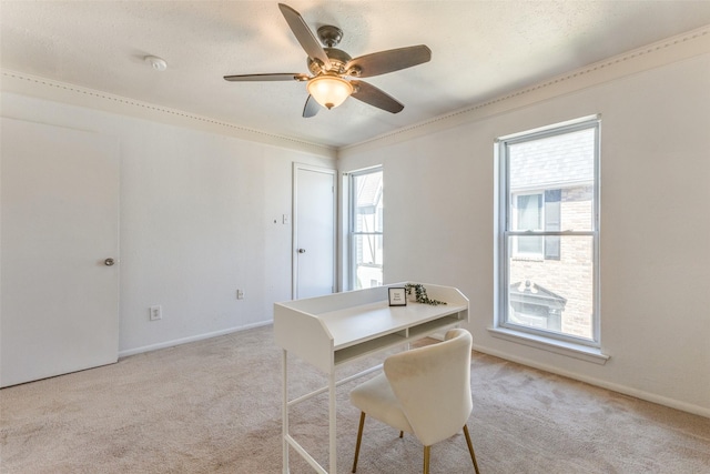 home office featuring light carpet, a healthy amount of sunlight, baseboards, and a ceiling fan