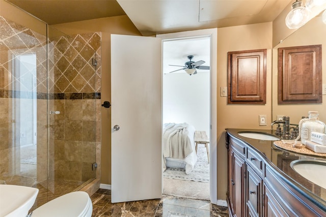 full bath featuring double vanity, toilet, a ceiling fan, a stall shower, and a sink