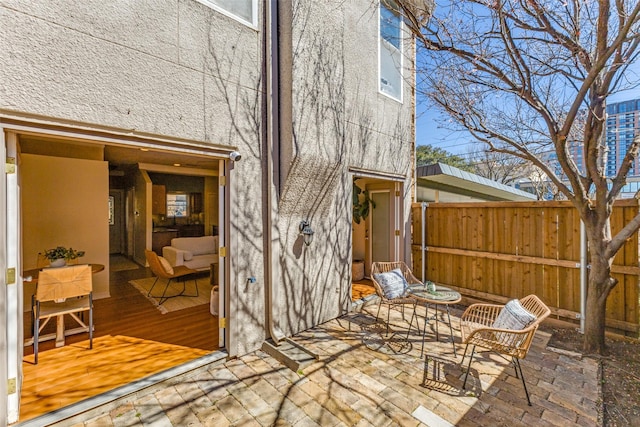 view of patio featuring fence