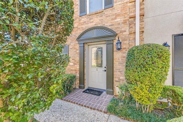 property entrance featuring brick siding