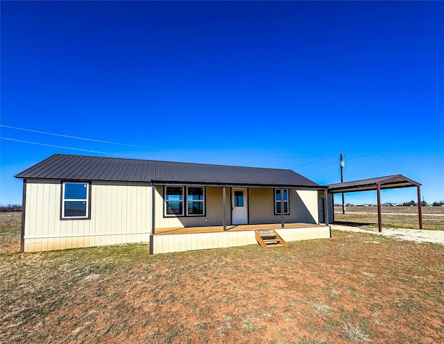 manufactured / mobile home featuring metal roof and a carport