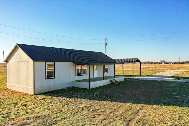 view of front of property with metal roof and a front yard