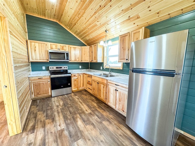 kitchen featuring lofted ceiling, a sink, light brown cabinetry, light countertops, and stainless steel appliances