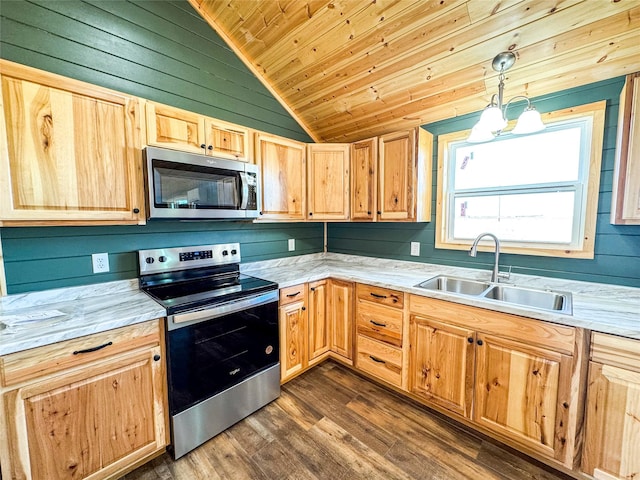 kitchen with light countertops, light brown cabinets, appliances with stainless steel finishes, and a sink