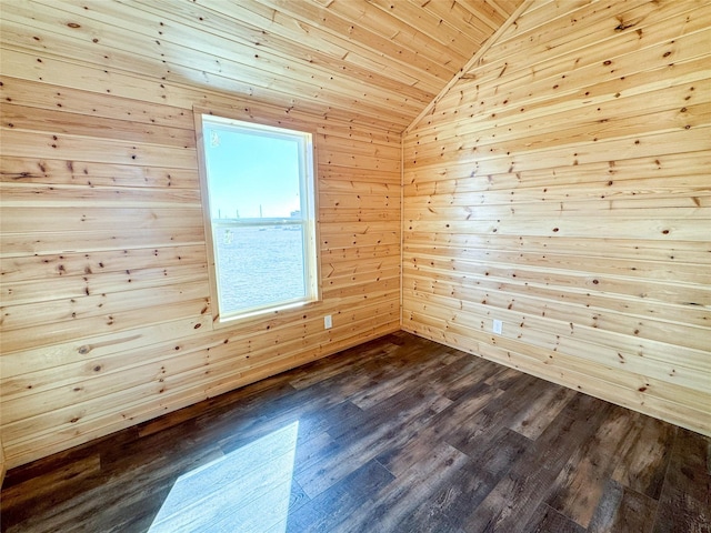 empty room featuring dark wood finished floors, wood ceiling, and vaulted ceiling