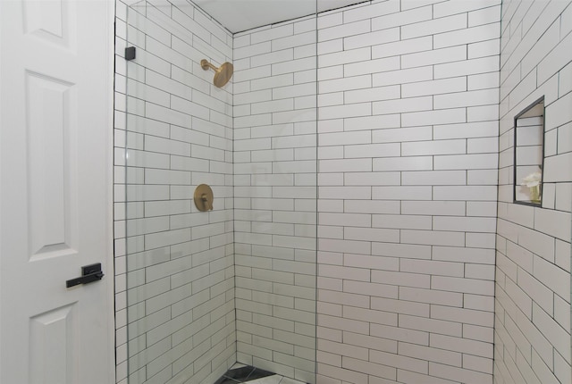 bathroom with a tile shower