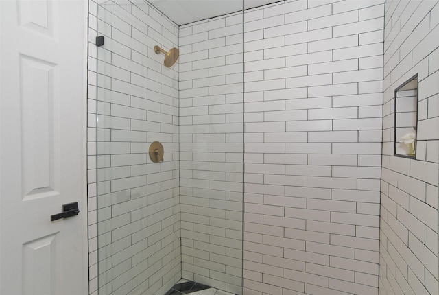 full bath with a tile shower