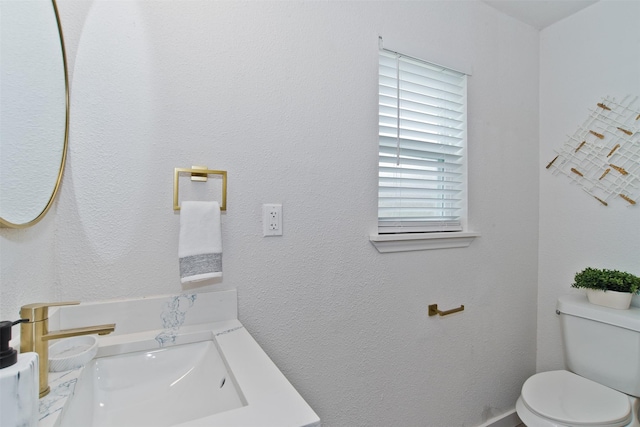 half bath featuring toilet and a sink