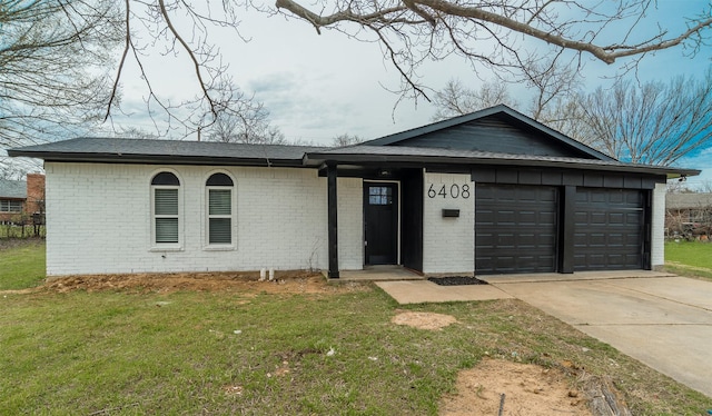 single story home with concrete driveway, a front lawn, an attached garage, and brick siding