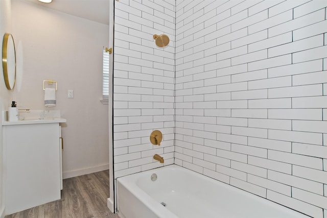 bathroom with vanity, wood finished floors, bathing tub / shower combination, and baseboards