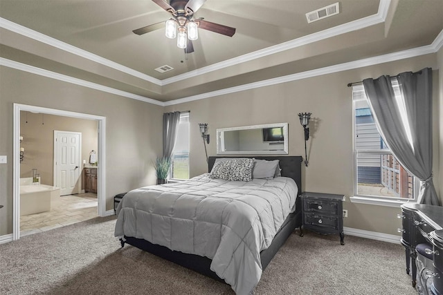 bedroom featuring carpet floors, crown molding, visible vents, and a tray ceiling