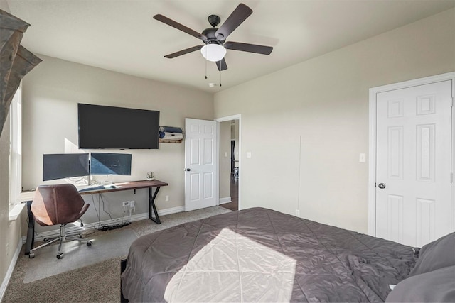 carpeted bedroom with ceiling fan and baseboards