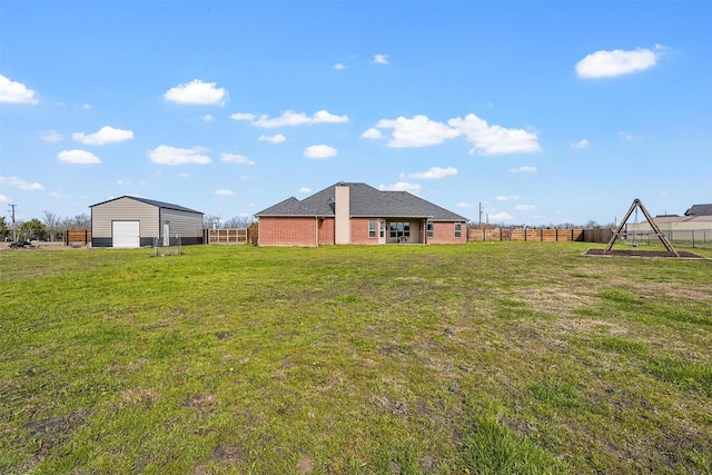 view of yard with an outdoor structure and fence