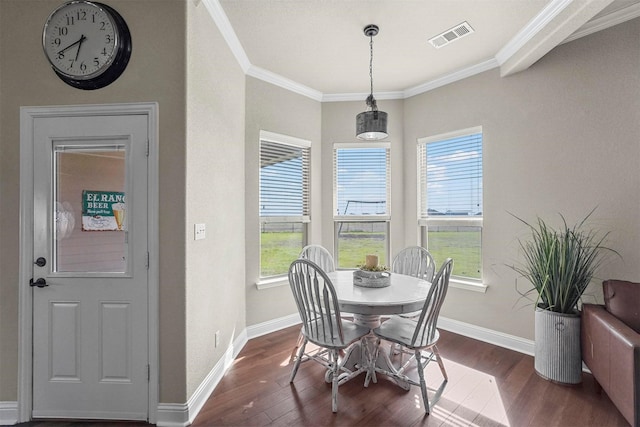 dining room with visible vents, dark wood-style flooring, and ornamental molding