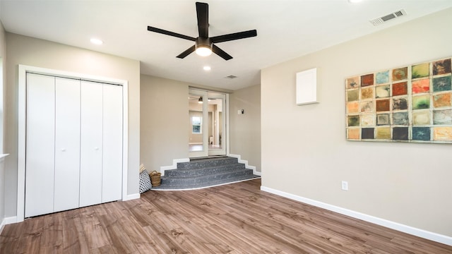 interior space with recessed lighting, visible vents, a ceiling fan, wood finished floors, and baseboards