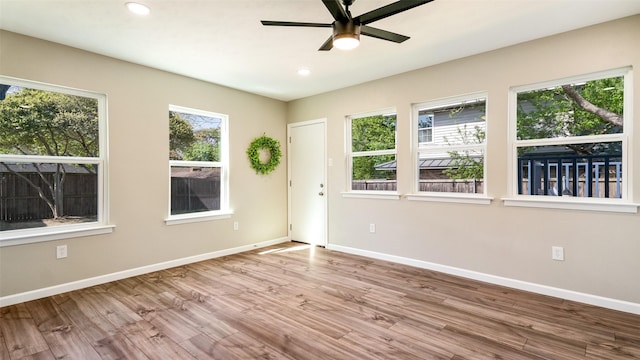 empty room featuring plenty of natural light and baseboards