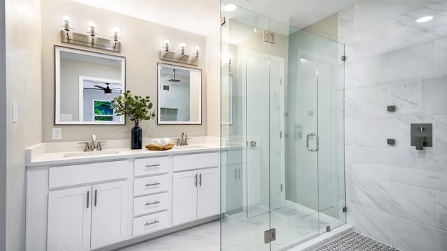 bathroom with marble finish floor, double vanity, a sink, and a shower stall