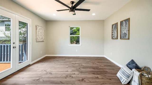 empty room featuring recessed lighting, french doors, baseboards, and wood finished floors