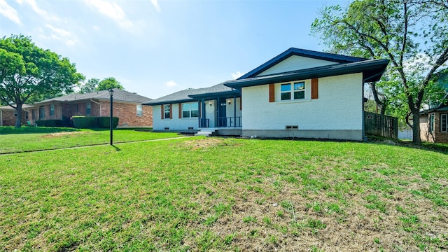 ranch-style house featuring brick siding and a front lawn