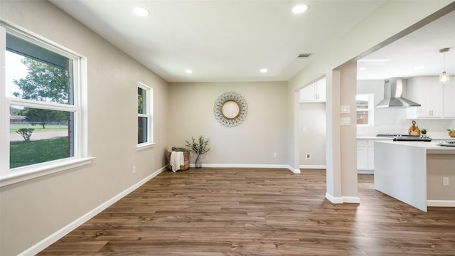 interior space with baseboards, visible vents, wood finished floors, and recessed lighting